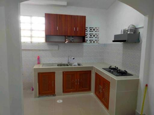 Modern kitchen with wooden cabinets and tiled walls