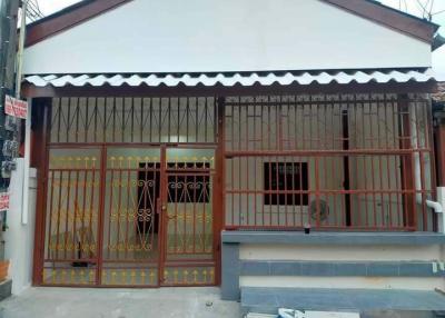 Front view of a single-story residential house with security grills