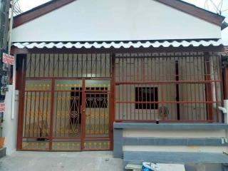 Front view of a single-story residential house with security grills