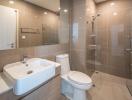 Modern bathroom interior with glass shower, toilet, and sink