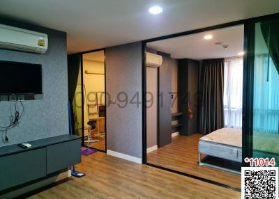 Modern bedroom with mirrored wardrobe and attached living area