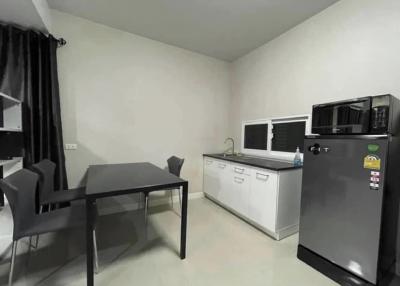 Modern kitchen with black appliances and a dining area