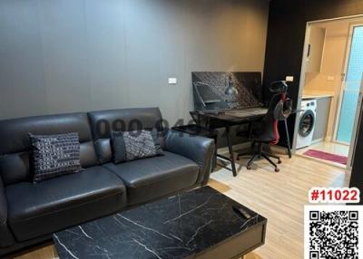 Cozy modern living room with a black sofa, marble-top coffee table, and a workstation