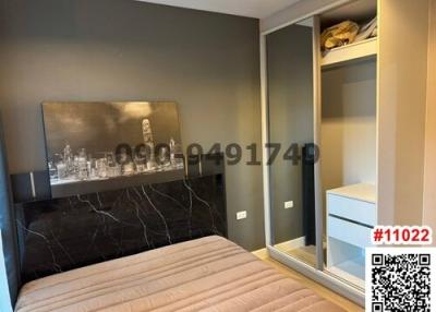 Cozy bedroom with built-in wardrobe and cityscape wall art