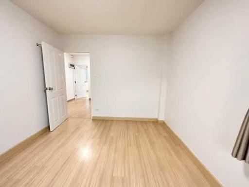 Bright empty bedroom with wooden flooring