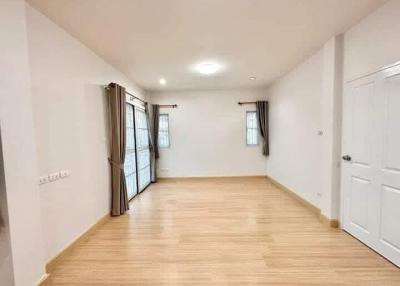 Bright and spacious empty bedroom with wooden flooring