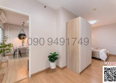 Modern bedroom with adjacent dining area, featuring hardwood floors and bright ambient lighting