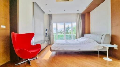 Modern bedroom with natural light and wooden flooring