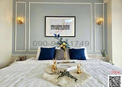 Elegantly styled bedroom with decorative moulding and welcoming wall art