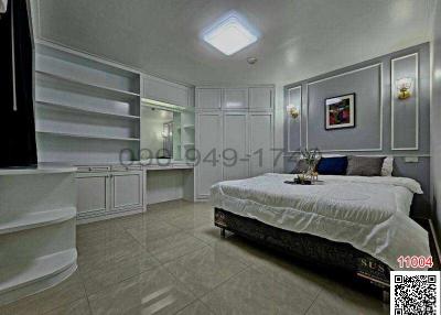 Modern bedroom with a large bed, built-in wardrobes, and elegant decor