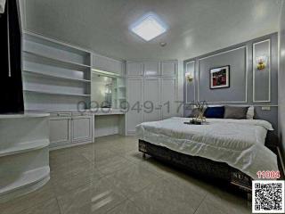 Modern bedroom with a large bed, built-in wardrobes, and elegant decor