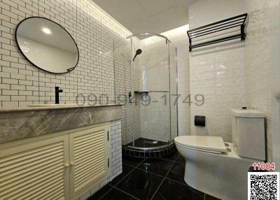 Modern bathroom with walk-in shower and white subway tiles