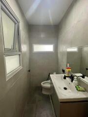 Modern bathroom with gray tiles and natural light