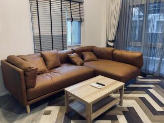 Cozy living room with large leather sofa and modern coffee table