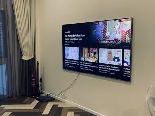 Modern living room with flat-screen TV and plush seating