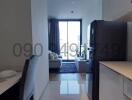 Modern apartment interior view showing kitchen and living area with natural light