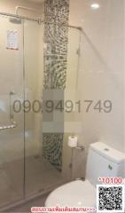 Modern bathroom with glass shower enclosure and mosaic tiles