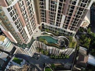 Aerial view of a modern residential building complex with pool