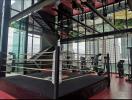 Modern gym facility with boxing ring and panoramic city views