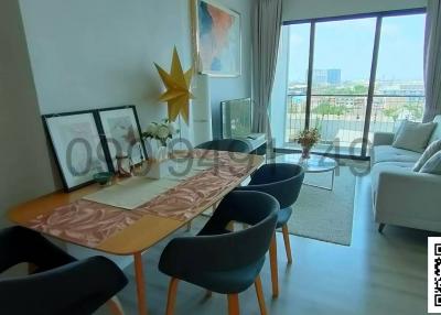 Modern living room with dining area and city view