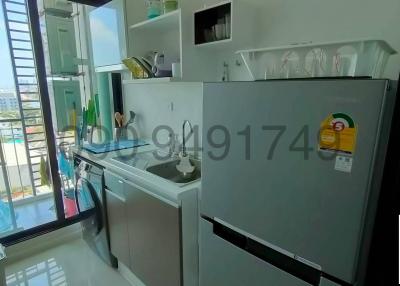 Modern kitchen with stainless steel refrigerator and city view