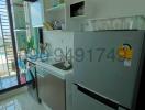 Modern kitchen with stainless steel refrigerator and city view