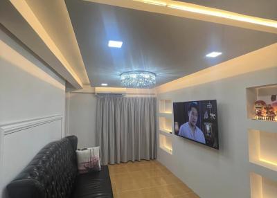 Modern living room interior with LED lighting, comfortable sofa, and mounted TV