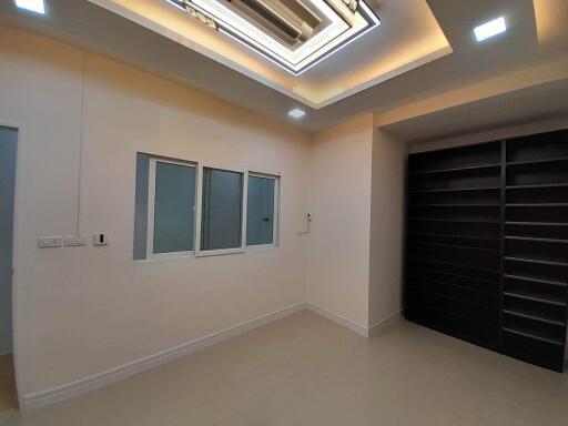 Spacious bedroom with modern lighting and built-in wardrobes