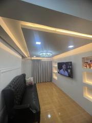 Modern living room interior with decorative lighting and a mounted television