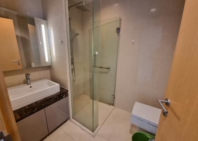 Modern bathroom with a walk-in shower and a marble-top vanity