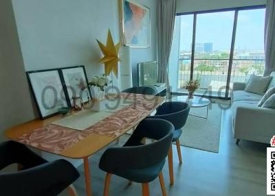 Contemporary styled living room with dining area and city view