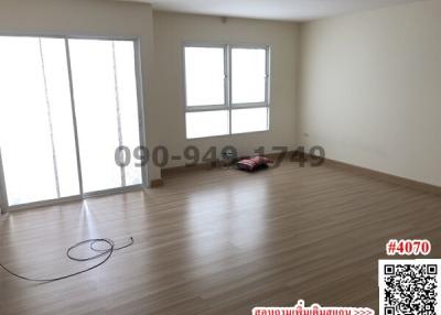 Spacious unfurnished bedroom with large windows and hardwood flooring