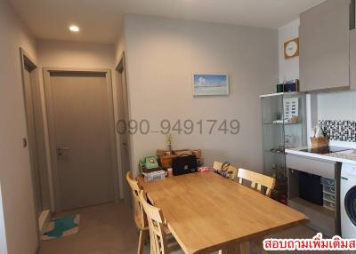 Compact and tidy kitchen with wooden dining table and modern appliances