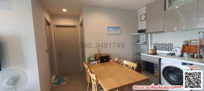 Compact and tidy kitchen with wooden dining table and modern appliances