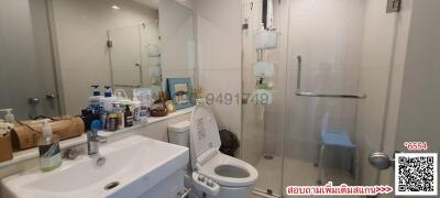 Modern bathroom with white fixtures and ample lighting