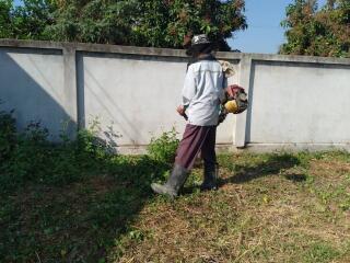 Person maintaining garden area outside a property