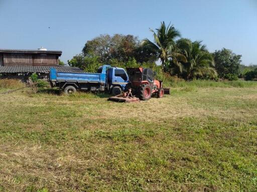 Rural outdoor setting with truck and tractor on a field