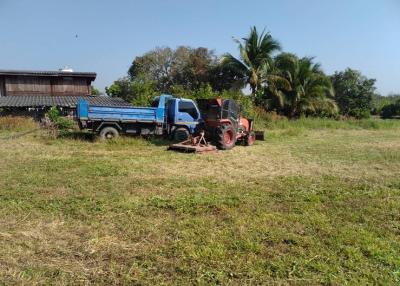 Rural outdoor setting with truck and tractor on a field