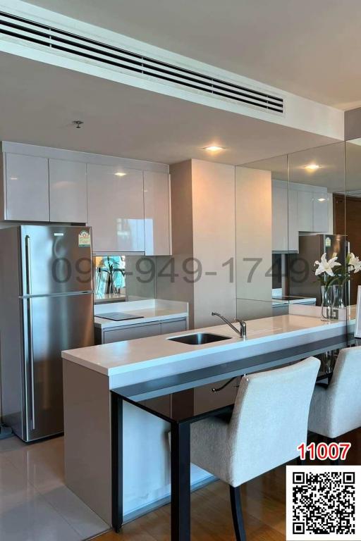 Modern kitchen with stainless steel appliances and breakfast bar