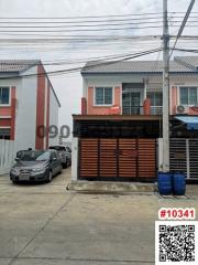 Two-story residential building with front gate and a car parked outside