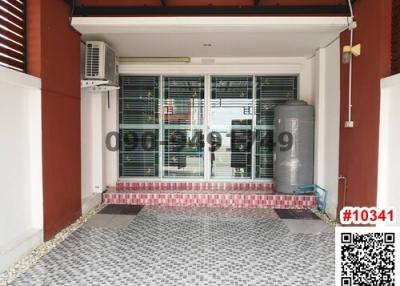 Spacious entrance of residential building with security grilles and patterned floor tiles