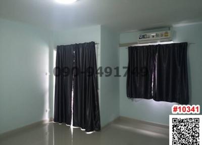 Bright and empty bedroom with large windows and air conditioning unit