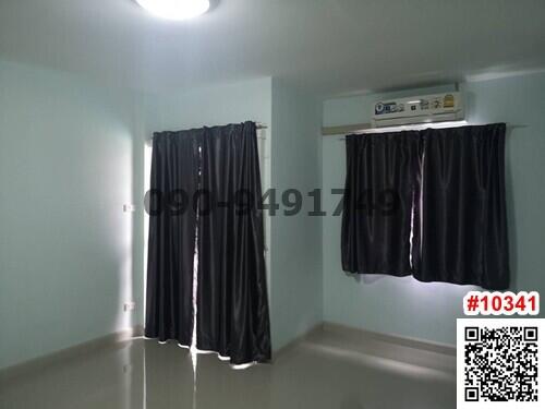 Bright and empty bedroom with large windows and air conditioning unit