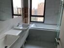 Modern bathroom with natural light and city view