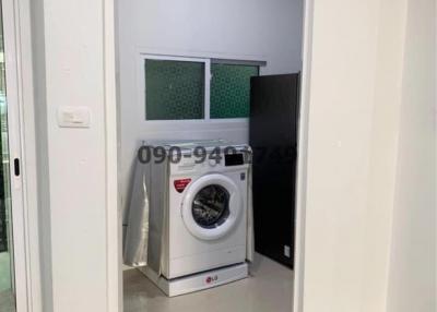Compact utility room with white washing machine