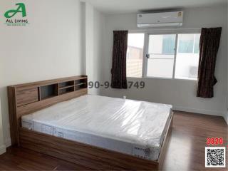 Modern bedroom interior with large bed and air conditioning unit