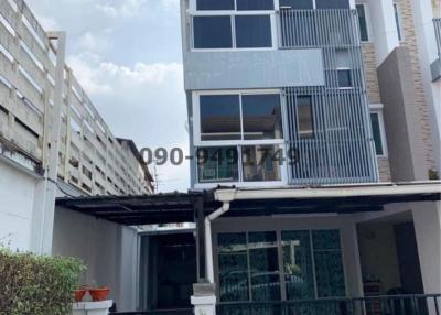 Modern multi-story residential home facade with balcony and garage