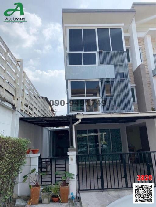 Modern multi-story residential home facade with balcony and garage