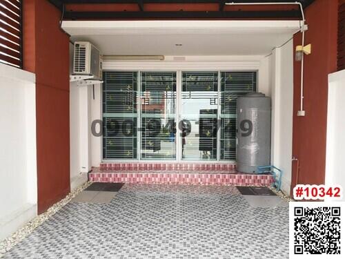 Covered entrance of a residential building with tiled flooring