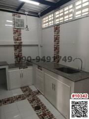 Modern kitchen with white cabinetry and tiled flooring